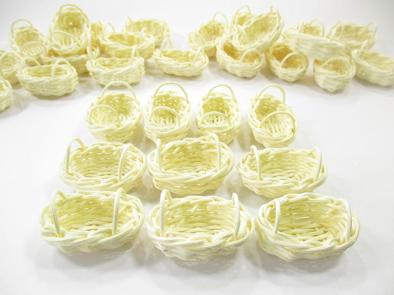 Bulk collection of handcrafted 1:12 scale oval wicker baskets arranged to showcase consistent size and traditional rustic style.