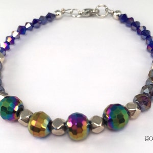 Unique iridescent colorized beads with 96 facets that project purple, blue, and gold make this bracelet an irresistible luxury!