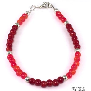 Gorgeous fall shades of cranberry red and orangey red glass beads make a beautiful casual stacking beaded bracelet