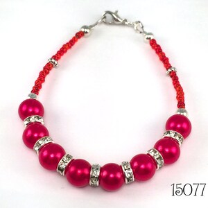 Ruby red pearl beads alternating with sparkling faceted clear channel set crystals and ending with red seed beads make a beautiful statement