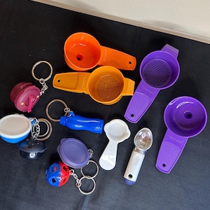 May include: A collection of colourful kitchen gadgets, including funnels, strainers, measuring spoons, and a scoop, all attached to keychains.