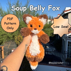 Könnte beinhalten: Ein Plüschfuchs mit orangefarbenem, weißem und braunem Fell, schwarzen Augen und einer braunen Nase. Der Text lautet Soup Belly Fox, PDF Pattern Only und Low Sew! Das Spielzeug hat einen weißen Bauch, weiß gespitzte Ohren und einen weißen Schwanz.