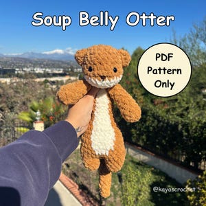 May include: A crocheted otter plushie with the text "Soup Belly Otter" above it. The otter is brown with a white belly and a white face. A circular graphic reads "PDF Pattern Only". The plushie is held up against a background of trees and a blue sky.