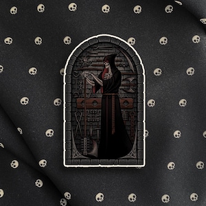 May include: A sticker featuring a Grim Reaper figure in a black hooded robe, holding chains and standing in a stone archway. The background is a black fabric with a pattern of small white skulls.