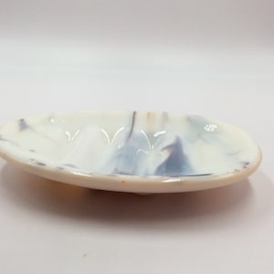 May include: White oval ceramic soap dish with a blue and gray marbled design.