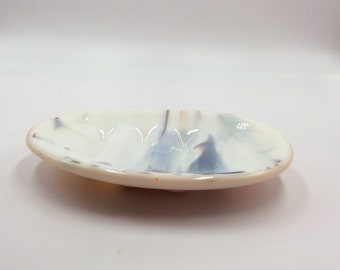 Oval fused glass soap dish in swirls of gray, brown, and cream with peach on reverse side