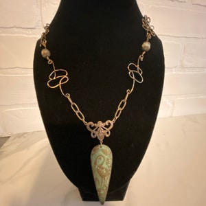 Beautiful hand made using recycled pieces and wire workwith crane at center