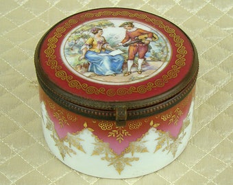 Antique hand gilded French porcelain jewelry casket, dresser trinket box, red and gold, gilt, enamel, hinged lid, courting couple rococo