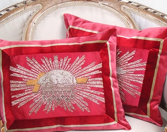 Pair of pillows w/ antique metallic embroidered ecclesiastic Jesus Christ symbols Agnus Dei & Dove on red silk, framed in striped velvet