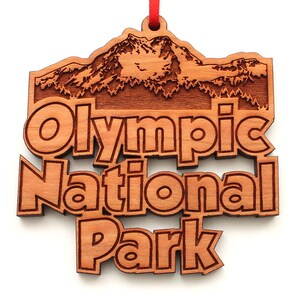 May include: Wooden ornament featuring a mountain range and the text "Olympic National Park".