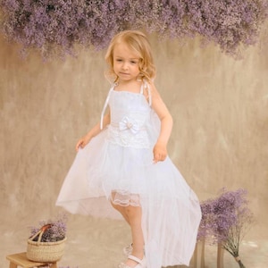 Children&#39;s girl white dress with lace - elegant dress for a birthday, flower girl at a wedding, photo shoot
