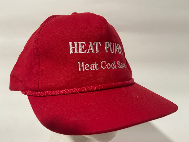 May include: Red baseball cap with white embroidered text that reads "HEAT PUMP Heat Cool Save".