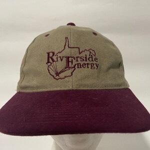 May include: A tan and maroon baseball cap with an embroidered logo of a state outline and the text "Riverside Energy".