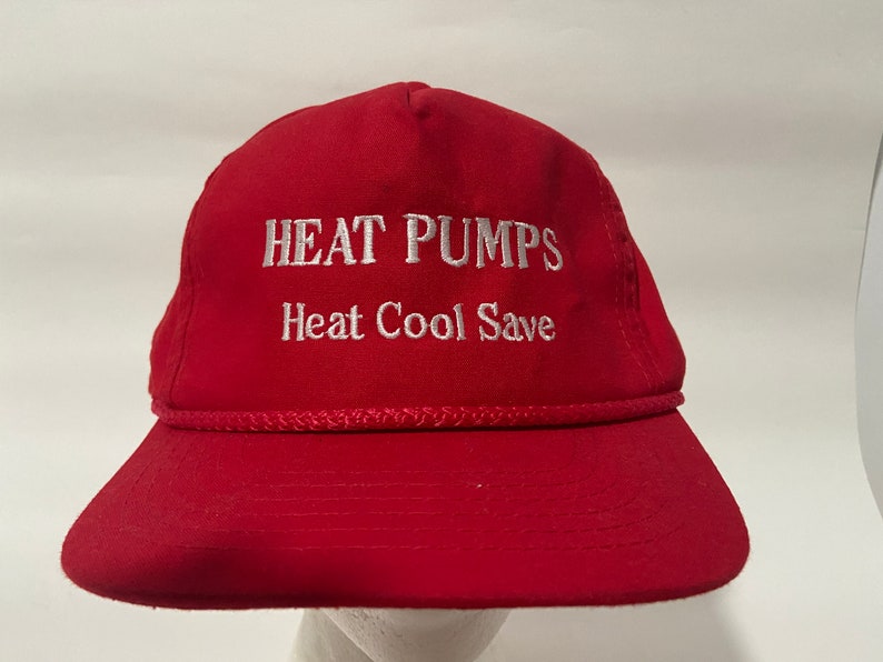 May include: A red baseball cap with white embroidered text that reads "HEAT PUMPS Heat Cool Save".