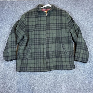 May include: A green and black plaid jacket with a full zipper closure and two front pockets. The jacket has a stand-up collar and is hanging on a white hanger.