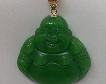 May include: A green jade pendant of a smiling Buddha, carved in detail, with a gold-tone bail.