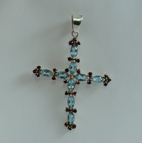 Blue Topaz and Garnet Cross Pendant with Sterling Silver