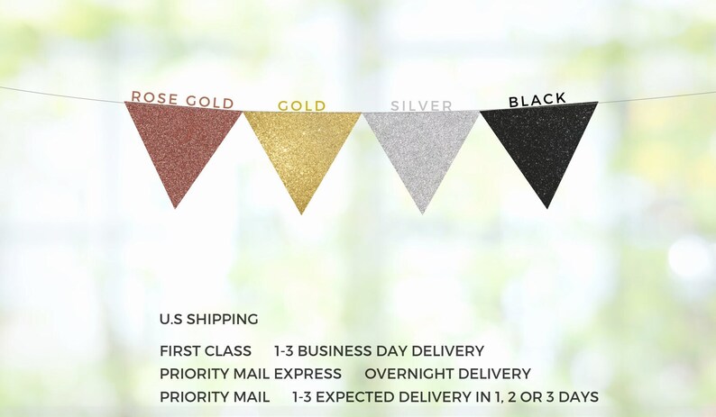 May include: A banner with four triangular flags in rose gold, gold, silver, and black. The flags are made of glitter fabric and are strung together with a thin string.