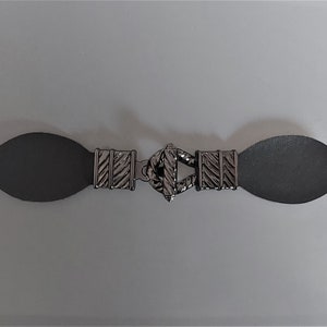 Black Brandenburg button closure in shiny steel color