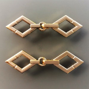 2 diamond-shaped sewing hooks 47 mm, gold-colored metal