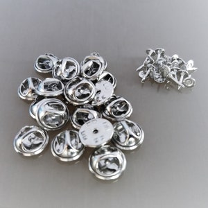 20 silver-colored metal pin holders