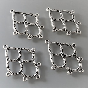 4 multi-row silver-colored metal connectors