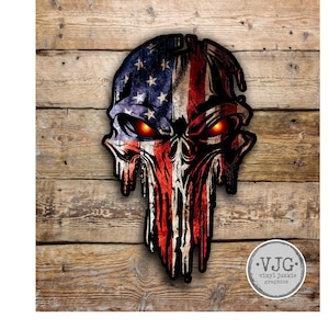 May include: A distressed American flag skull graphic with red, white, and blue colors. The skull has glowing red eyes. The graphic is on a wood background with a small logo that says "VJG vinyl junkie graphics".