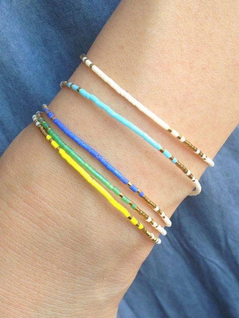 yellow, blue, gold , gren , white beaded seed bead bracelets on arm, Everyday bracelet tiny gold bracelet gold bead bracelet Every day Jewelry