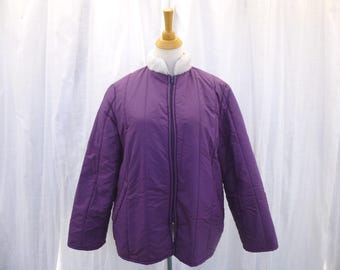 May include: A purple quilted jacket with a white faux fur collar and a zipper closure.