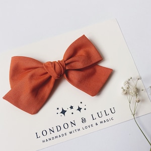 Burnt Orange 100% cotton bow handmade in USA on baby nylon headband lead free hair clip or pigtail clip set solid basic pumpkin rust brown