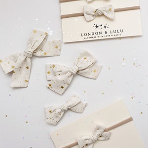 White + Gold metallic stars Rifle Paper co cotton fabric hair bows golden starlight star lite pattern night sky primavera