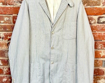 May include: A light blue and white pinstriped blazer featuring a notched lapel, a three-button front closure, one chest pocket, and two lower patch pockets. The jacket includes a white interior lining and a Polo by Ralph Lauren brand label.