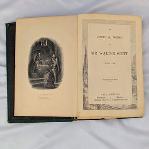 May include: An open antique book titled The Poetical Works of Sir Walter Scott with Life. The left page features a black and white engraving of figures in a stone chamber, while the right page displays the title, publisher Gall & Inglis, and locations.
