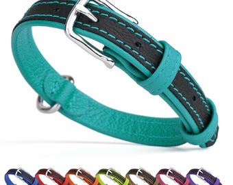 May include: A turquoise leather dog collar with black stitching and a silver buckle. The collar is shown with a variety of other colors, including red, orange, green, brown, pink, and purple.