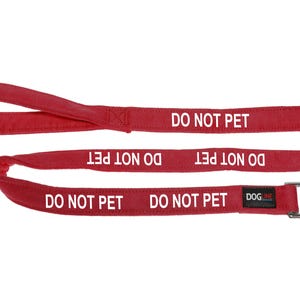May include: Red dog leash with a silver clip and the text "DO NOT PET" repeated five times. The leash is made by DOGME.