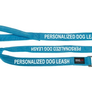 May include: A bright blue dog leash with a silver clip. The leash is personalized with the text "PERSONALIZED DOG LEASH" in white.