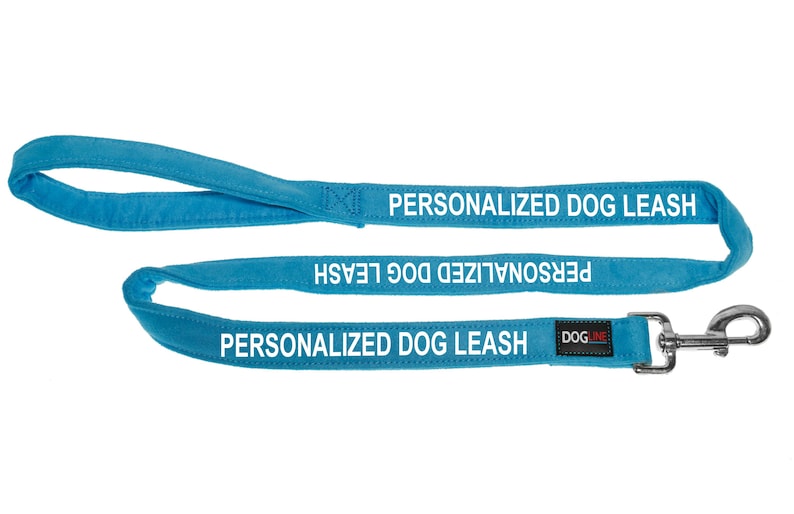 May include: A bright blue dog leash with a silver clip. The leash is personalized with the text "PERSONALIZED DOG LEASH" in white.