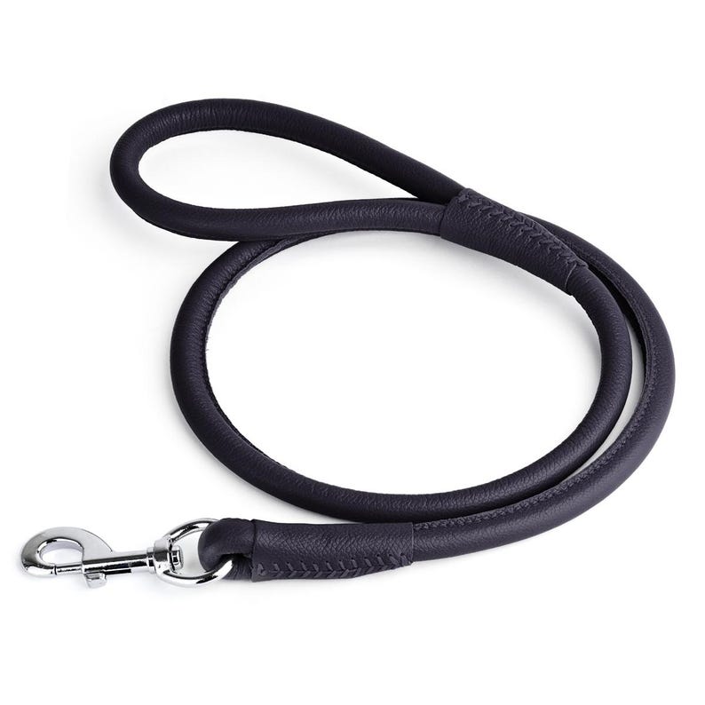 May include: A dark navy blue leather dog leash with a silver-colored metal clasp. The leash is looped and has a rounded, tubular design. The leather appears to be stitched at the handle and the clasp attachment.