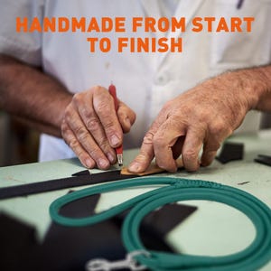 May include: An artisan's hands working on a leather product, with the text "HANDMADE FROM START TO FINISH" in orange. A teal dog leash is in the foreground. The artisan is using a red tool to work on a piece of leather.