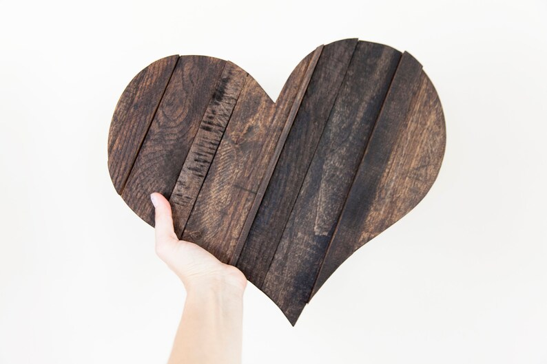 May include: A dark brown wooden heart-shaped sign made from reclaimed wood planks.