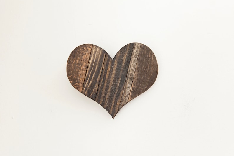 May include: A dark brown wooden heart-shaped wall decor made from reclaimed wood planks.