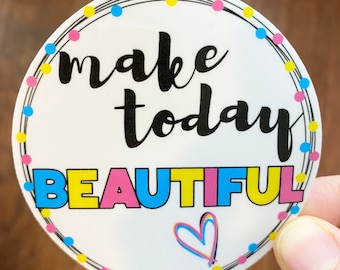 May include: A round sticker with the words "make today BEAUTIFUL" in black, yellow, pink, and blue. The sticker has a dotted border with pink, blue, and yellow dots and a colorful heart graphic.