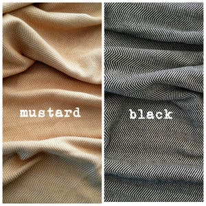 May include: Two fabric swatches, one mustard yellow and the other black, both with a herringbone pattern. The word "mustard" is printed on the yellow swatch, and "black" is printed on the black swatch. The fabric is folded and draped.