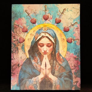 Könnte beinhalten: Ein Gemälde einer Frau mit einer Dornenkrone, die eine blaue Robe trägt und mit gefalteten Händen betet. Der Hintergrund ist ein blaues und rosafarbenes Blumenmuster.