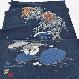 May include: Indigo blue fabric with a Japanese-style design. The fabric features a detailed illustration of a tree with red berries, a small structure, and two rabbits. The design also includes white accents and text.