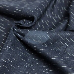 May include: A close-up of a dark blue fabric with a subtle white stripe pattern. The fabric has a soft, textured feel and is perfect for crafting projects.