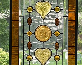 Stained glass transom window panel. Vintage heart dishes and honey bee.