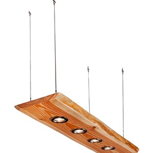 May include: A wooden pendant light fixture with four light bulbs. The fixture is made from a natural wood plank with a rough-hewn edge. The light bulbs are recessed into the wood and have a black finish.