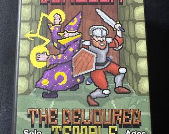 May include: A rectangular board game box titled Puzzle Dungeon: The Devoured Temple. The cover features pixel art of a purple wizard casting yellow magic and a knight with a sword and shield standing before a wooden door. Text includes Solo 30 min. Ages 14+.