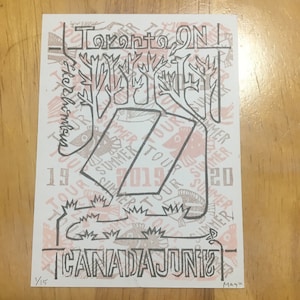 May include: A black and white illustration of a tree with the text "Toronto ON" at the top and "CANADA JUNI" at the bottom. The tree is surrounded by the text "SUMMER TOUR 2019" repeated multiple times.